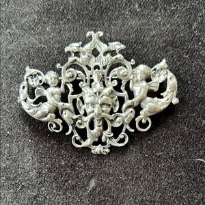 Intricate Silver Brooch with Cherub Motif
